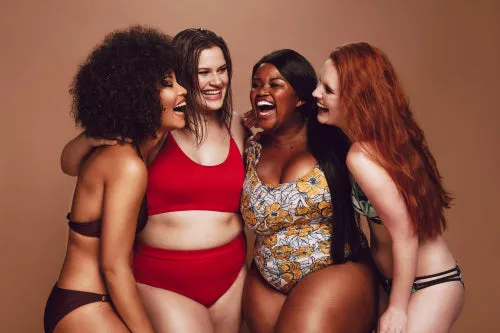 Different size females in bikinis laughing together
